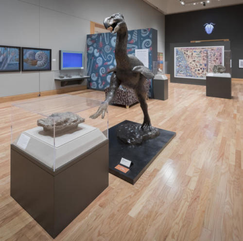 Gary Staab's life sized bronze of Gastornis, a giant prehistoric bird with a fossilized footprint in front of it from the Palmer area.