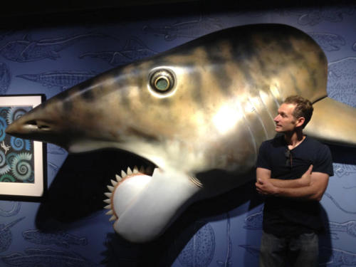 Gary Staab standing by his Helicoprion sculpture